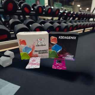 Kodagenix Pre-workout and Pump Gummies in a gym infant of dumbbells